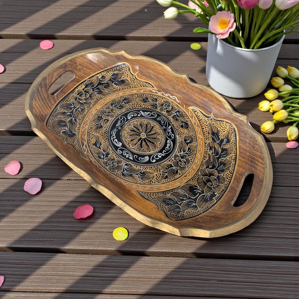 A rectangular shallow wooden tray with a dark finish. The center features handpainted gold and black botanical motifs, including delicate floral scrolls and leaf patterns against the natural wood grain.