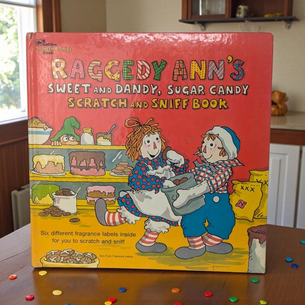 A square hardcover children's book featuring Raggedy Ann and Andy on a vibrant cover. The illustrations are in a classic 1970s style with bold colors and rounded characters. The surface shows a clean, glossy finish.