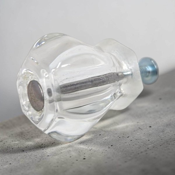 A glass cabinet knob with a rounded, mushroom-style silhouette. The glass is transparent and faceted at the base, resting on silver-tone metal hardware with mounting screws included.