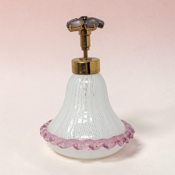 A bulbous glass perfume bottle with a swirl of white, pink, and yellow filigree ribbons. It features a clear, gold-flecked orb stopper and a flared rim. The delicate internal latticework creates a complex, spiraling cage effect.