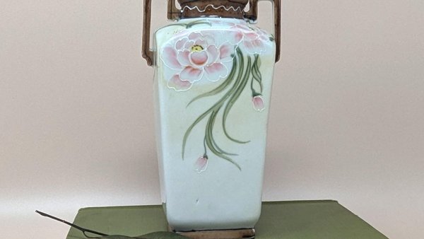 A rectangular porcelain vase with squared handles. It features hand-painted pink peonies with white raised outlines on a cream background, with brown trim at the rim and base.